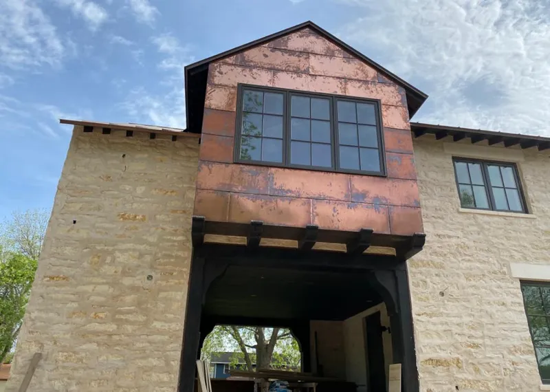 Copper metal panel facade on a stone building for Skylight Installation in Hillcrest